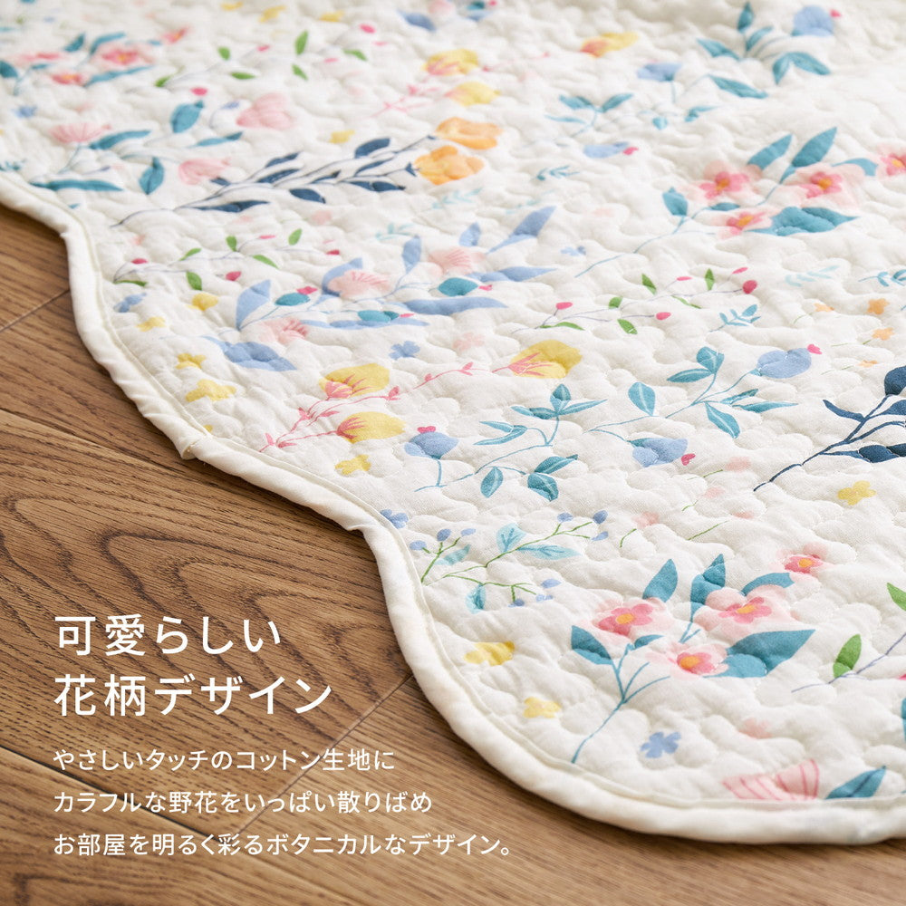 アイボリーの優しい色合いにカラフルな花柄がプリントされたキルトのマルチカバー